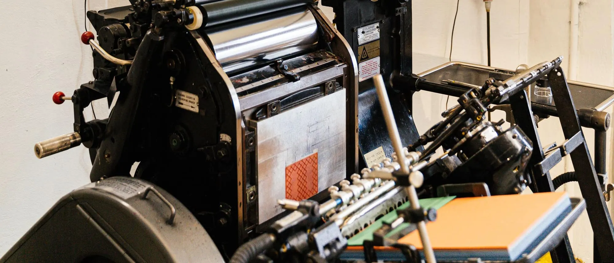 Printed brochures and typography samples in a design studio