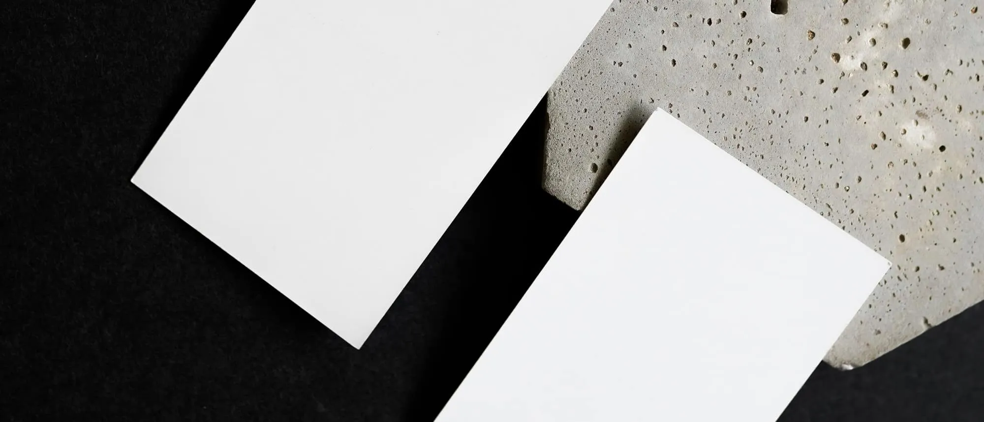 Blank business cards on textured fabric showing stock and finish