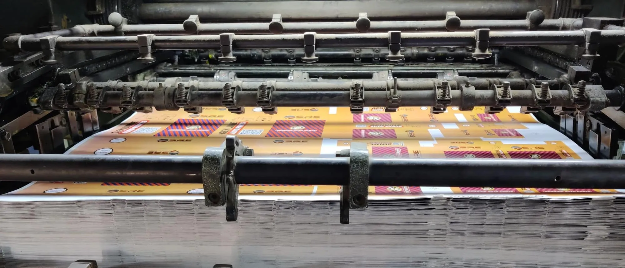 A digital press feeding paper sheets through its rollers