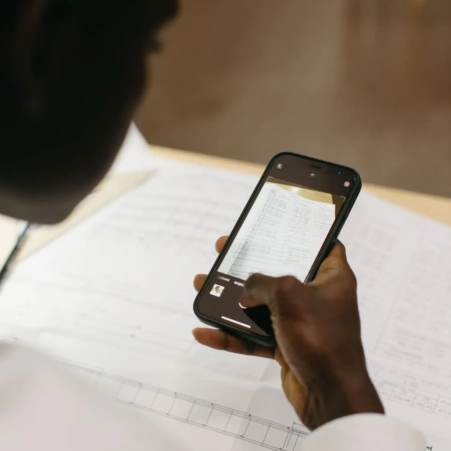 Someone photographing a paper document with a phone