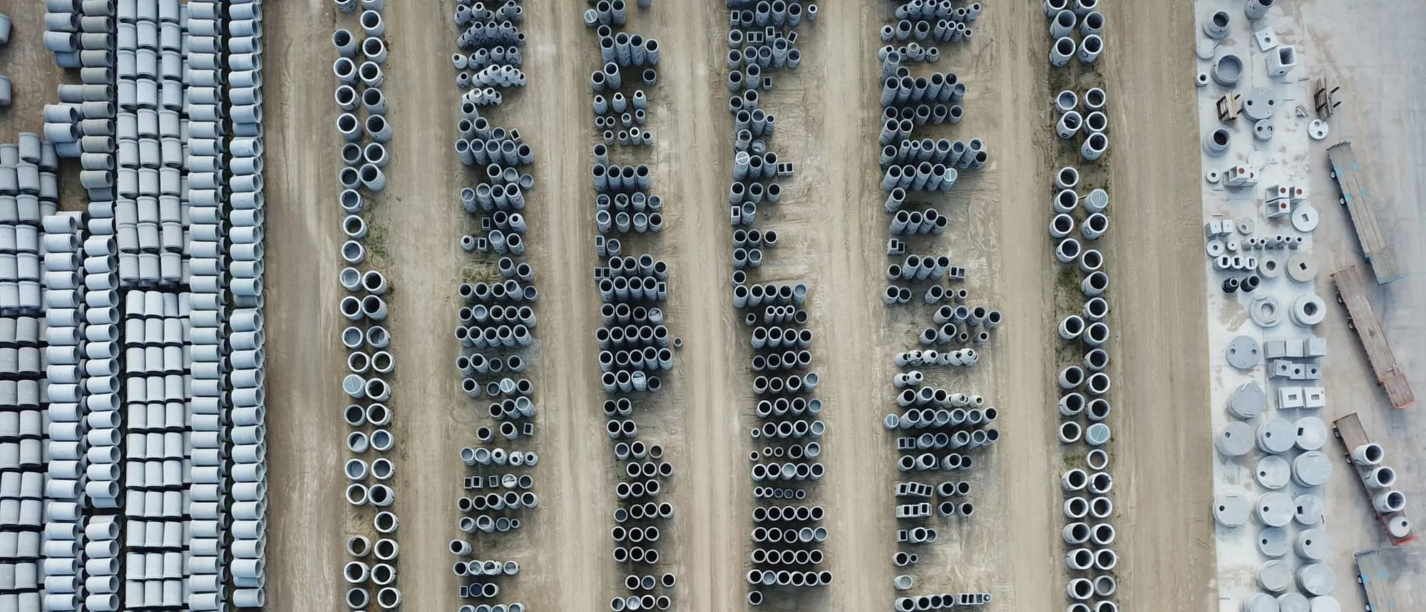 An aerial view of a precast concrete yard with stacked product
