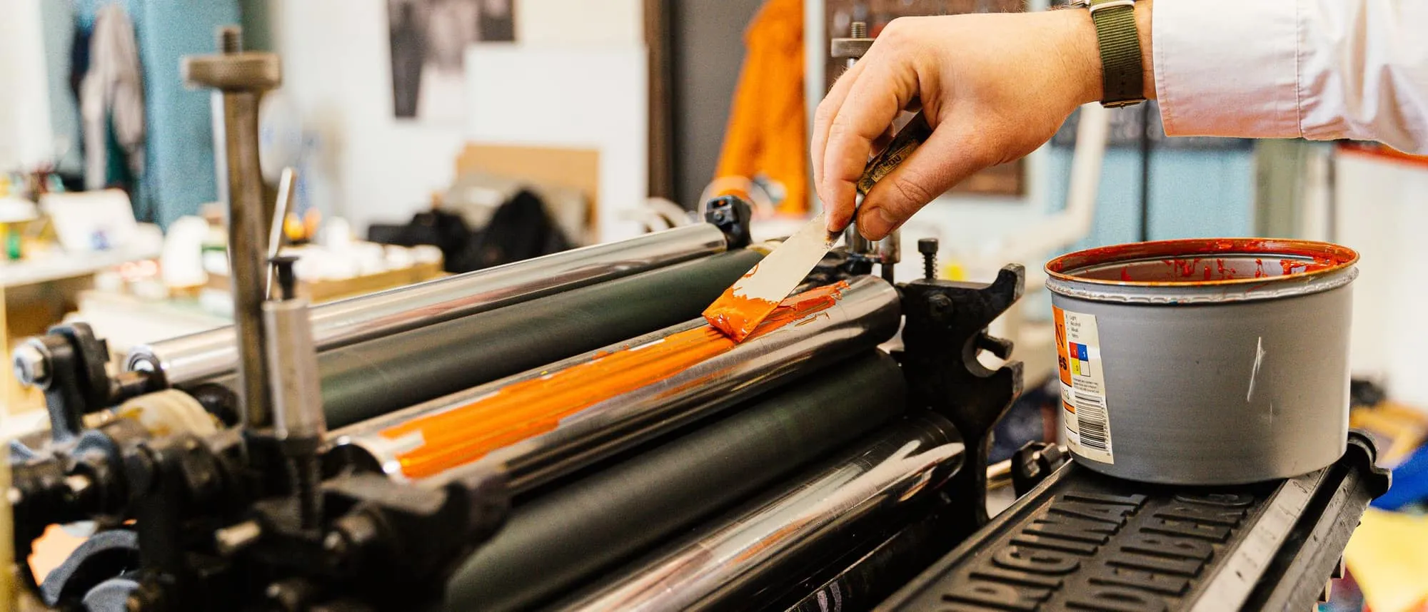 Ink being worked across an offset press roller by hand