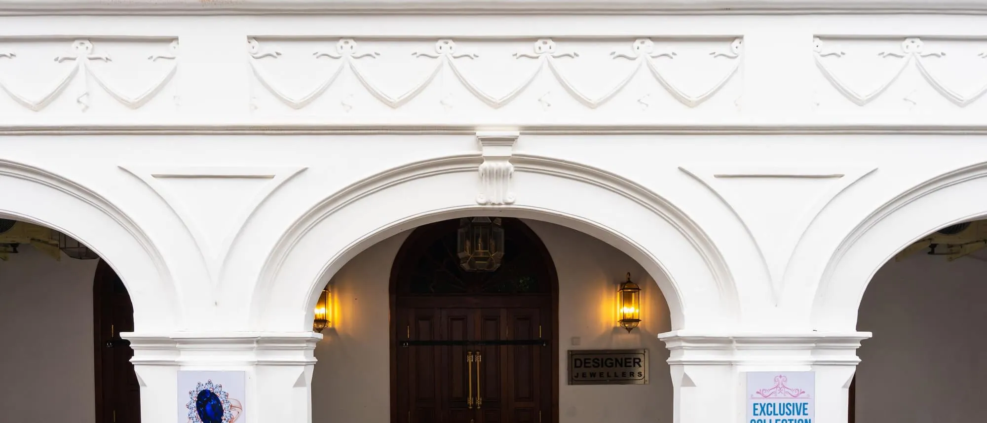 A branded entrance archway with fascia signage