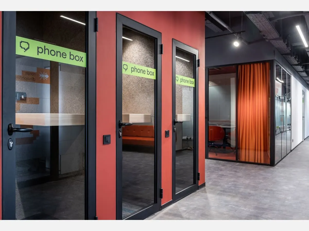Labelled meeting booths in an open-plan office