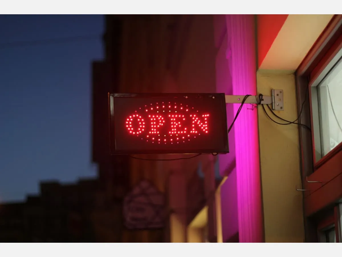 An illuminated open sign in a shop window