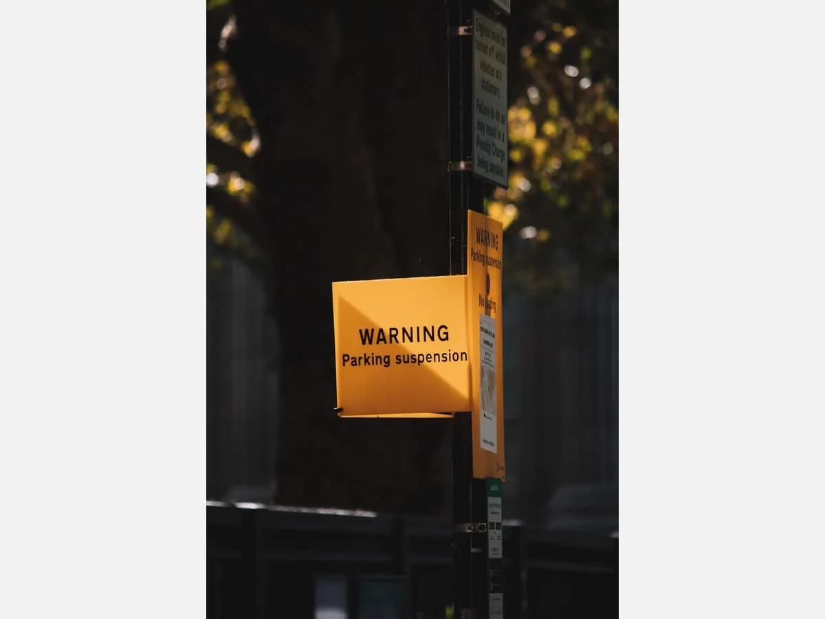 A yellow notice board giving instructions outside a building